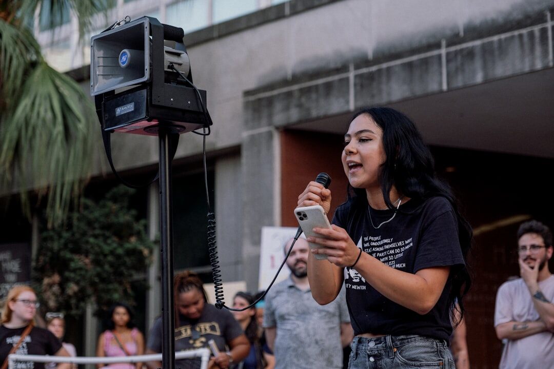 Field reporter holding a microphone while reporting live